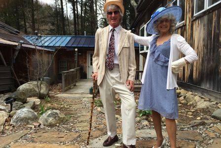 Elderly couple dressed stylishly outdoors.