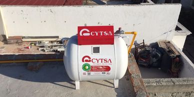 A white CYTSA water tank on a rooftop.