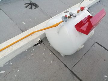 White propane tank with safety valves on a rooftop.