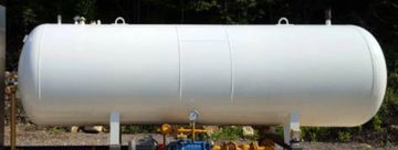 Large white industrial storage tank outdoors.