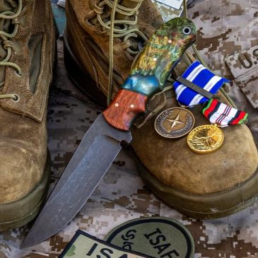 Military boots, a decorative knife, medals, and ISAF patches arranged carefully.