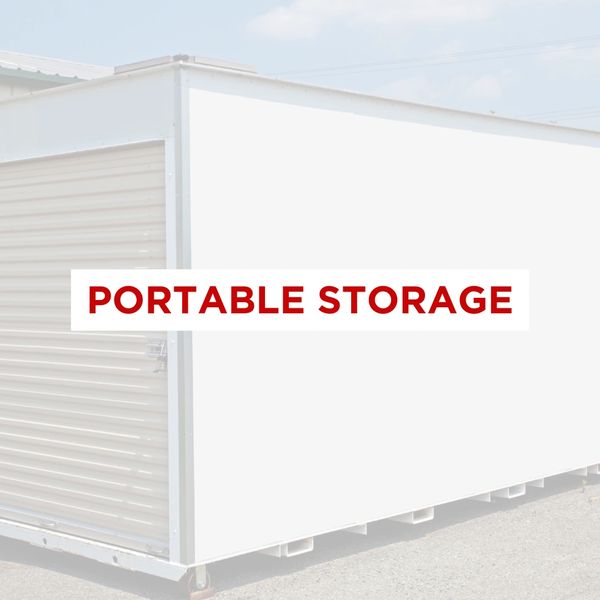 Portable storage unit with roll up door outside commercial building. 