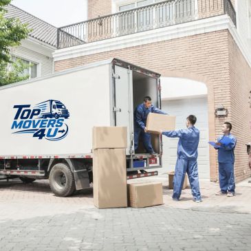 Movers unloading boxes from a truck outside a house.