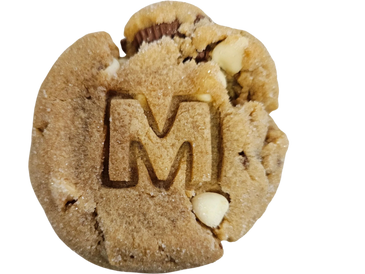 A close-up of a partially eaten cookie with a large 'M' imprint.