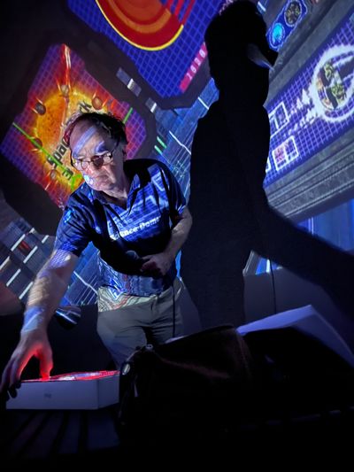 A presenter of Science Dome busy at the controls of his ship!