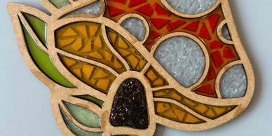 A colorful stained glass flower with intricate patterns and textures.