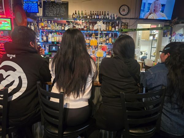 Endzone Sports Bar & Grill bar seating with cold beer on tap and TVs playing live sports in Woodburn