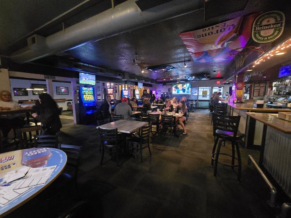 Customers enjoying food and drinks at Endzone Sports Bar & Grill, a popular place to eat and watch s