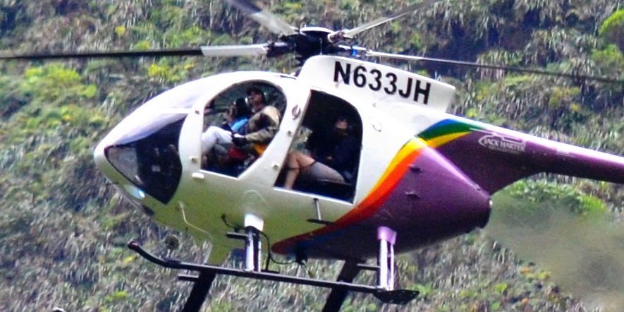 doors off helicopter with pilot looking out