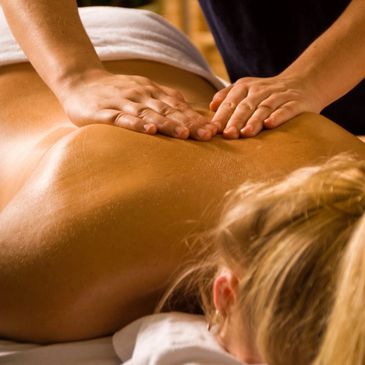 Person receiving a relaxing back massage from a therapist.