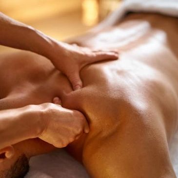 Close-up of a person receiving a deep tissue back massage.