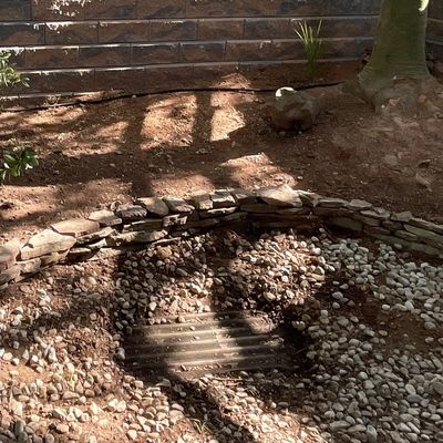 Concrete dry well with metal grate for drainage of surface water 