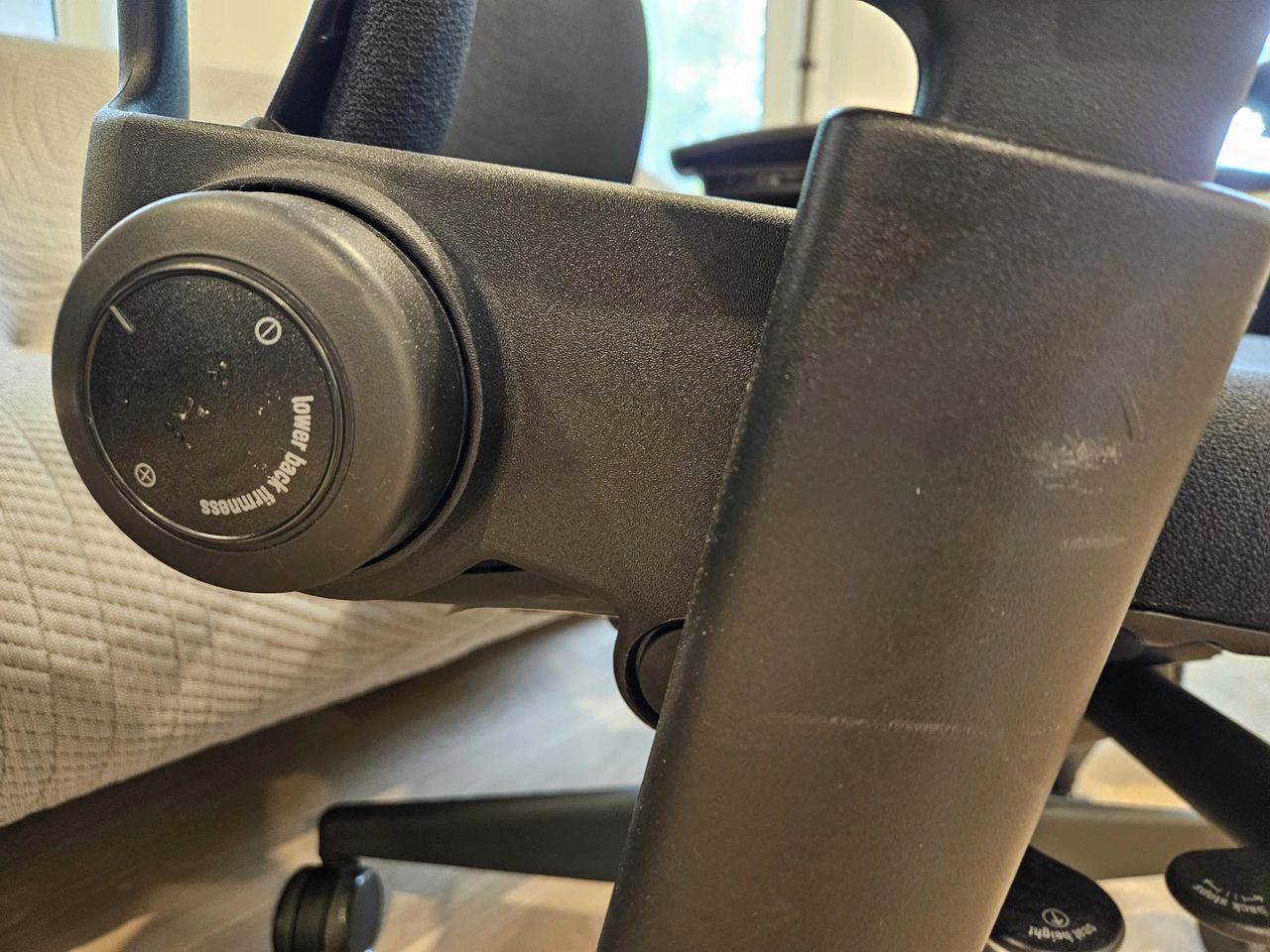 Grade "B" lower back adjustment wheel and arm trim of a Steelcase Leap v2.