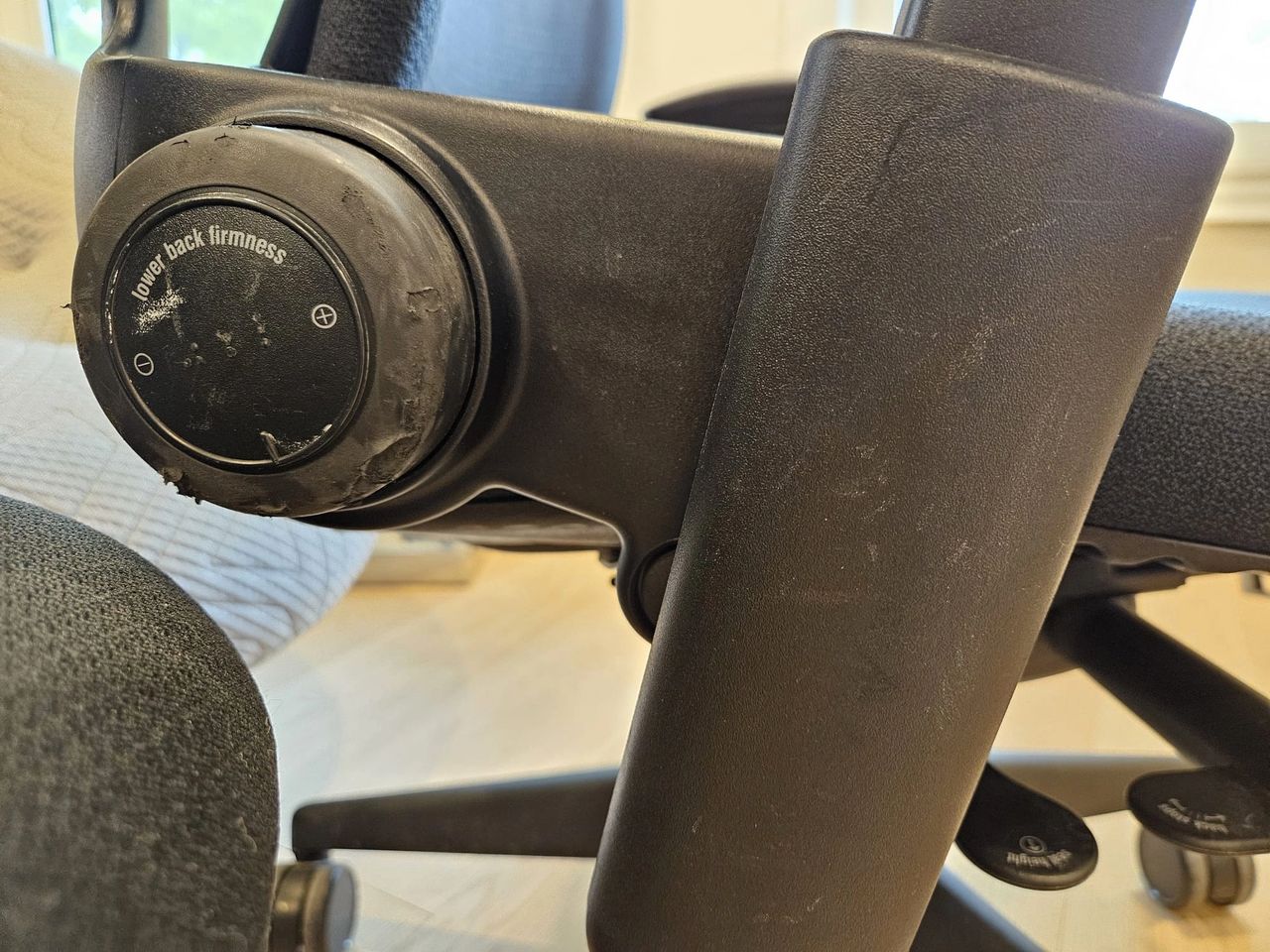 Grade "C" lower back adjustment wheel and arm trim of a Steelcase Leap v2.