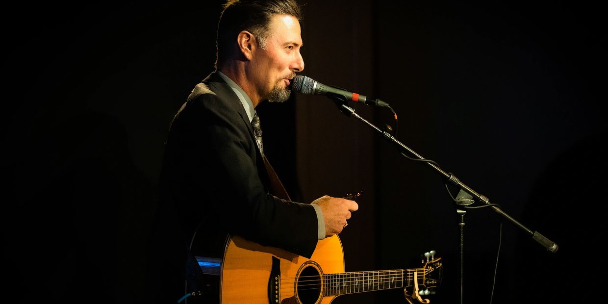 Jonathan Sarty singing with guitar