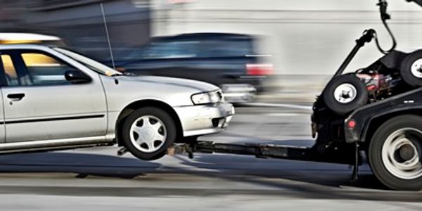 Truck taking a white car on the display