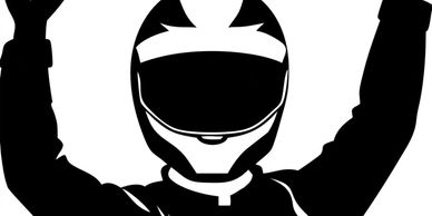 Silhouette of a racer raising arms in victory.