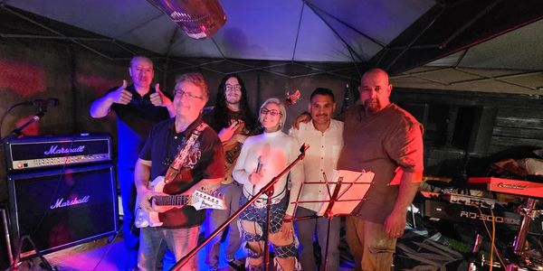 The band members pose together on stage before downbeat.....