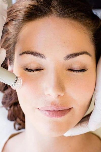 Using advanced skin care tools to provide facial for woman