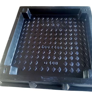 Black square drainage cover with diamond pattern.