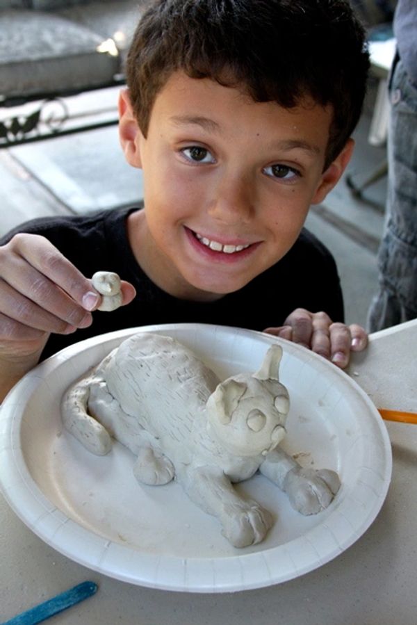 kids clay art class in pleasant Hill, boy showing clay cat