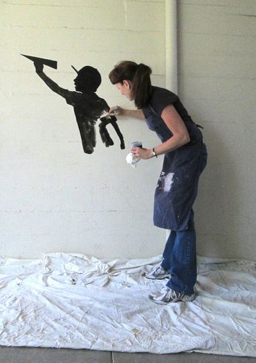 jeannette fromm painting a mural