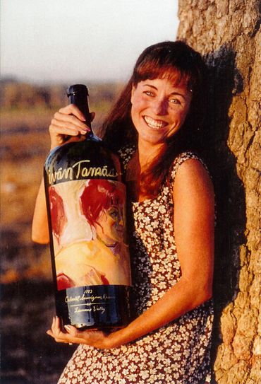 Jeannette Fromm holding a large painted wine bottle