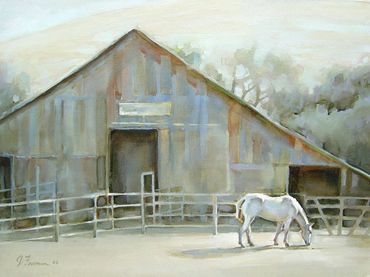 horse in front of a barn in the morning light
