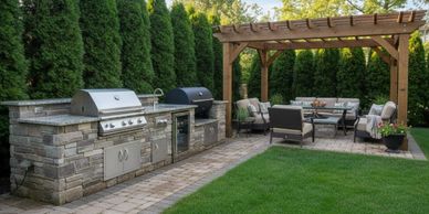 Elegant outdoor kitchen and seating area with pergola in lush backyard.