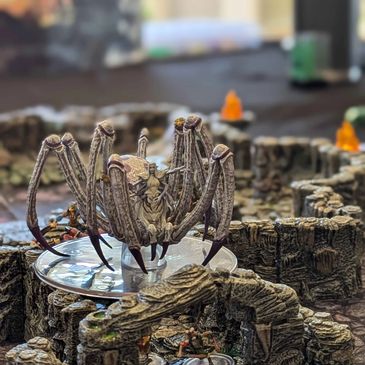A giant spider mini figurine in a fantasy dungeon board game.