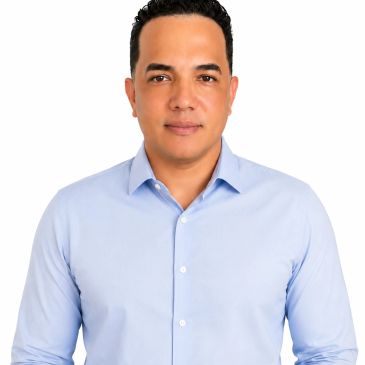 Man in light blue shirt looking at the camera.