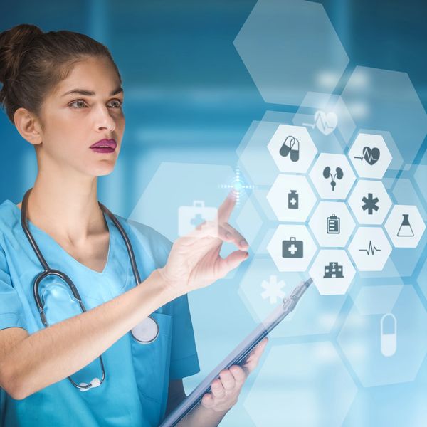 Healthcare professional interacting with virtual medical icons on a transparent screen.