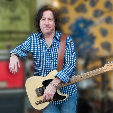 Alan Grant holding a guitar