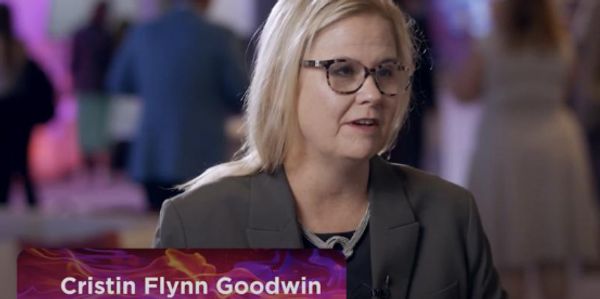 Woman speaking in an interview setting.