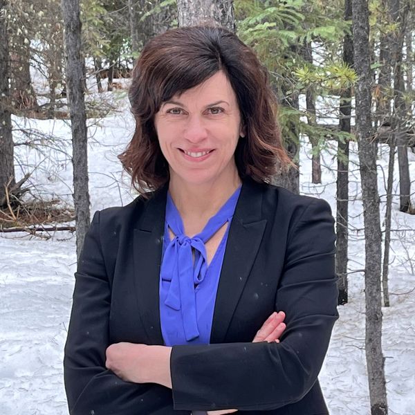 Jennifer Budgell standing in a forest with snow.