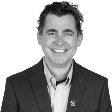 Smiling man in a blue suit jacket and light blue shirt.