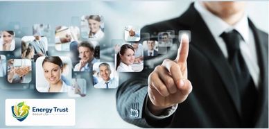 Businessman interacting with virtual network of professional portraits and Energy Trust logo.