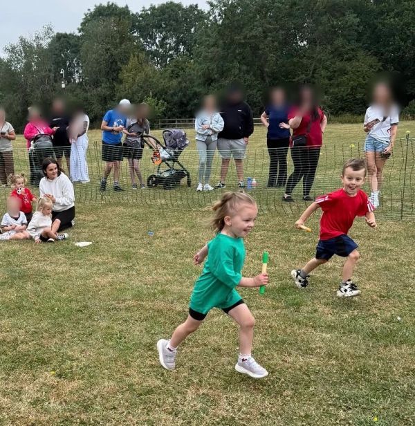 Children racing outdoors with joyful expressions.