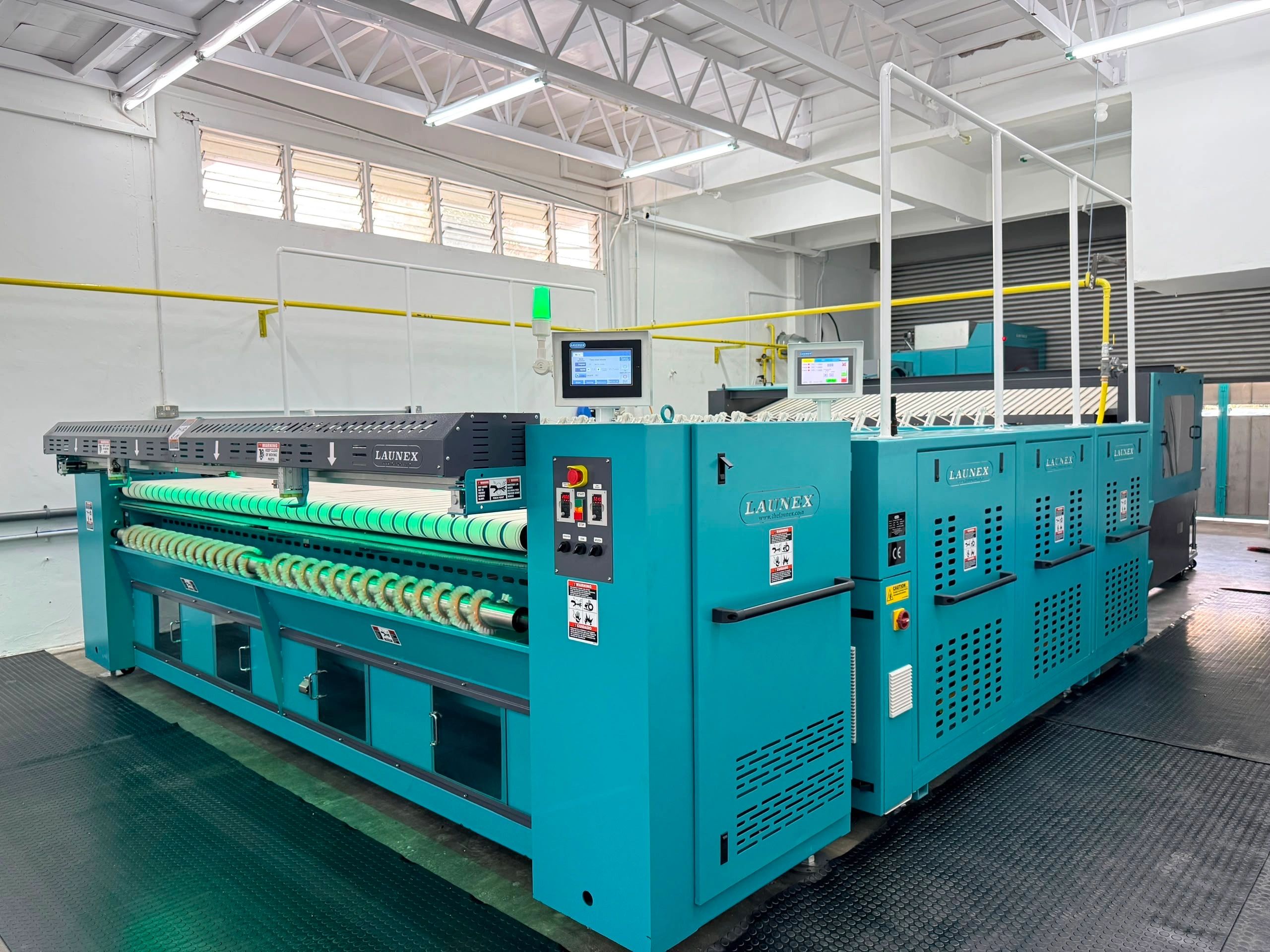 Industrial textile machinery in a factory setting.