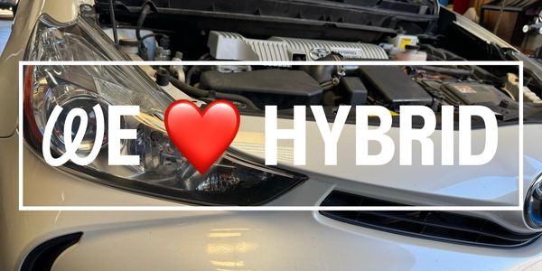 Close-up of a hybrid car's engine with text overlay expressing love for hybrid technology.