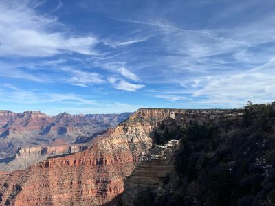 Scenic view of Grand Canyon with layered rock formations under a blue sky.