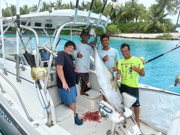The crew of Bora Bora Fishing Charters with a happy guest and his yellowfin tuna!