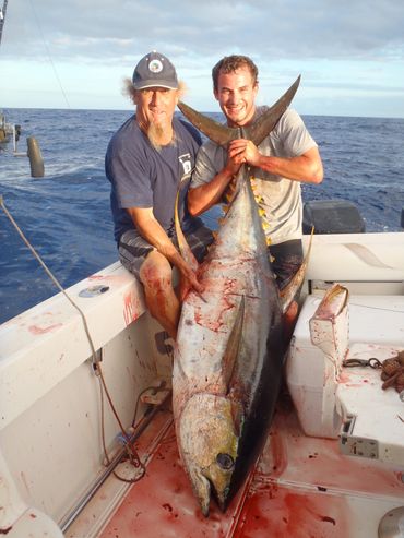 Happy guys after landing a big yellowfin tuna with Bora Bora Fishing Charters.