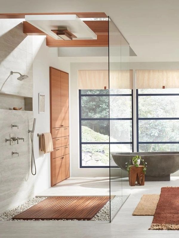 Light, airy bathroom complete with rainhead, wood tones