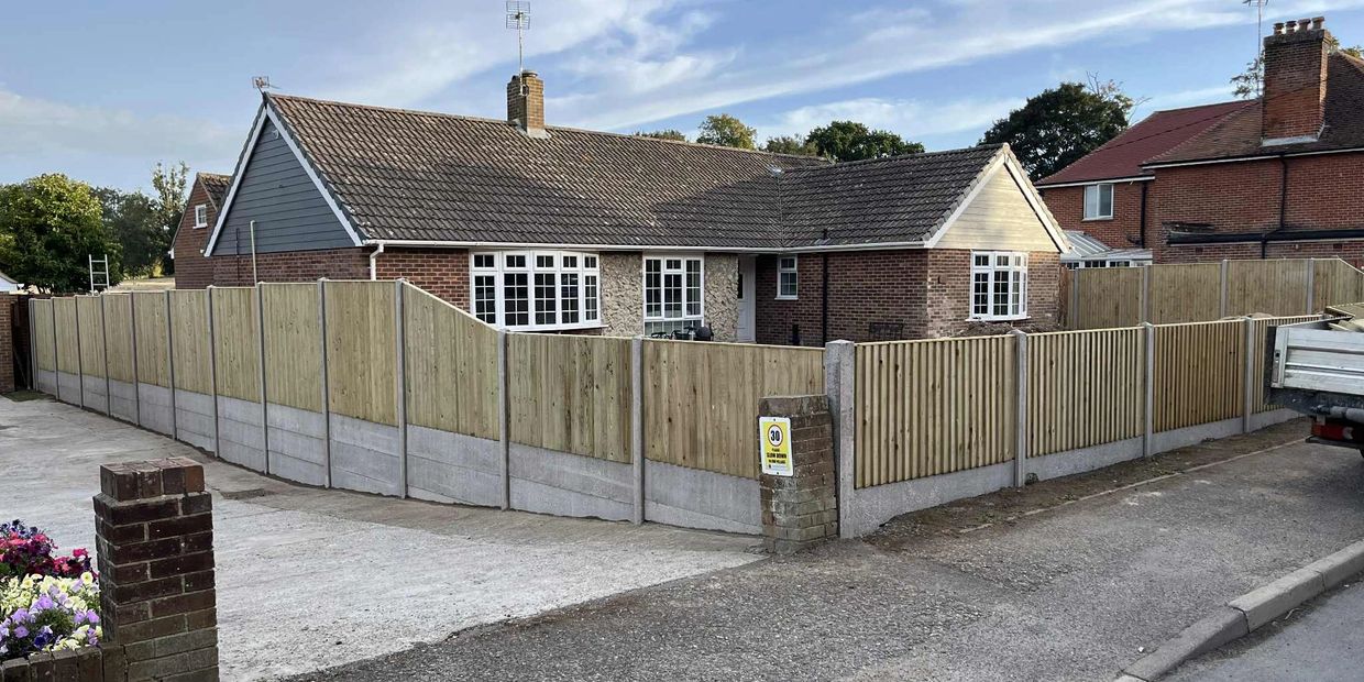 Suburban house surrounded by a new wooden fence.