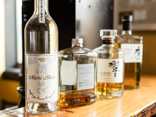 Close-up of Japanese whiskies and sake bottles at Mura Izakaya bar on Kauaʻi