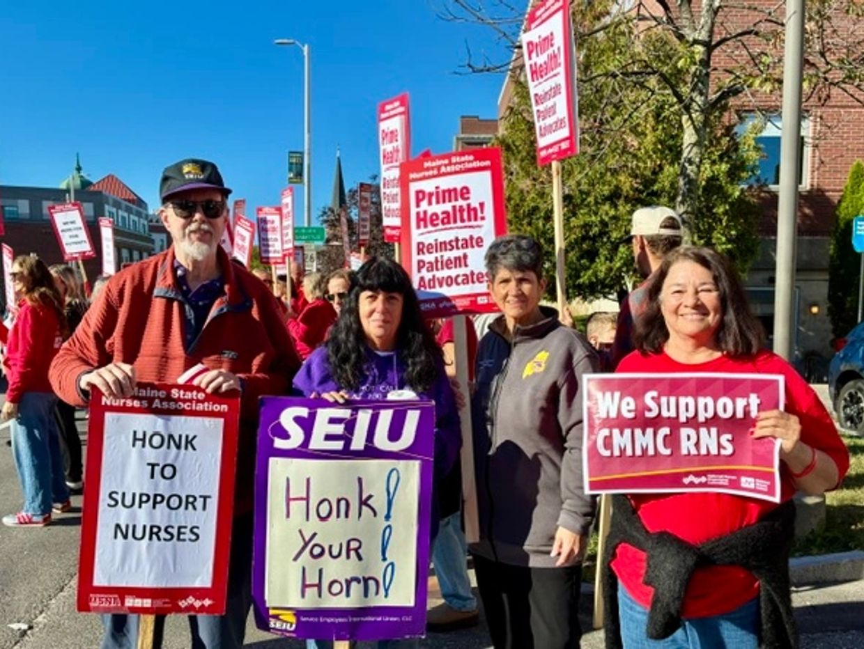 People holding signs supporting nurses and patient advocates.
