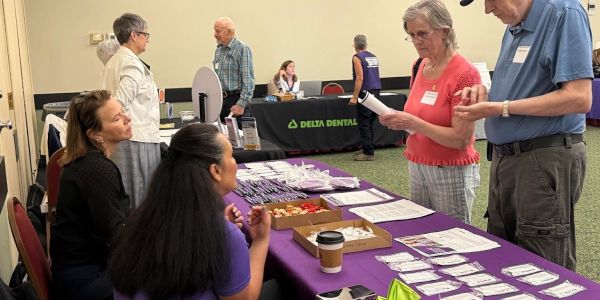 People interacting at a health fair or informational event.