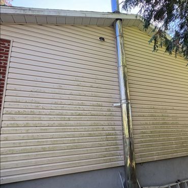 Dirty exterior wall with a metal pipe.