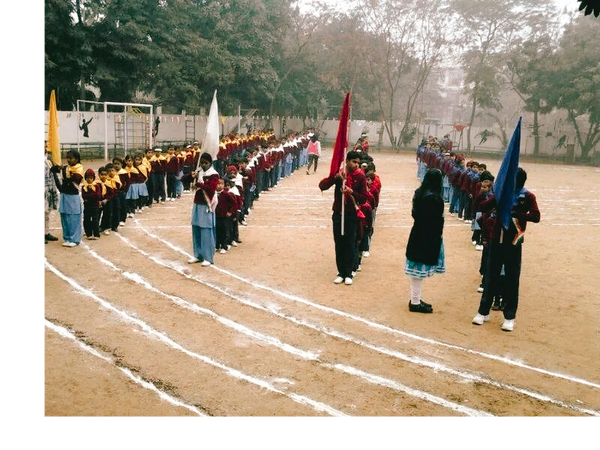 Students lined up in organized rows holding colorful flags on a sports field.